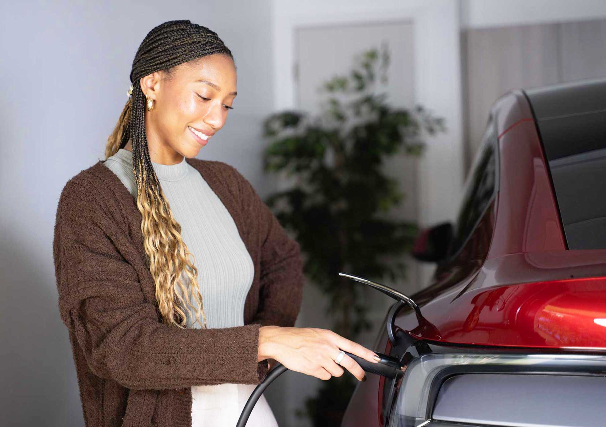 Texas homeowner plugging in their EV to a Charge Pro-installed Level 2 Wall Connector – fast overnight charging