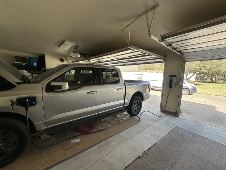 Ford F-150 Lightning charging in a garage from a wall-mounted charger