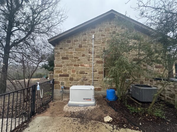 Generac standby generator installation on concrete pad beside home