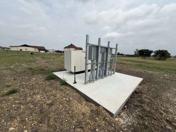 whole home generator installation on concrete pad with electrical service equipment