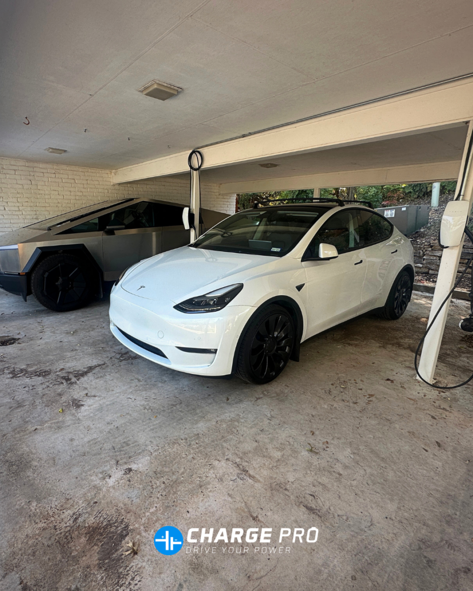 Tesla Level 2 home EV charger installed by ChargePro Texas charging a Tesla Model Y in a residential carport with a Tesla Cybertruck parked nearby.