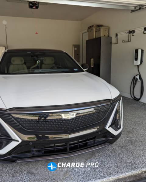 Cadillac electric vehicle charging in a home garage using a wall-mounted Level 2 EV charger installed by ChargePro Texas.