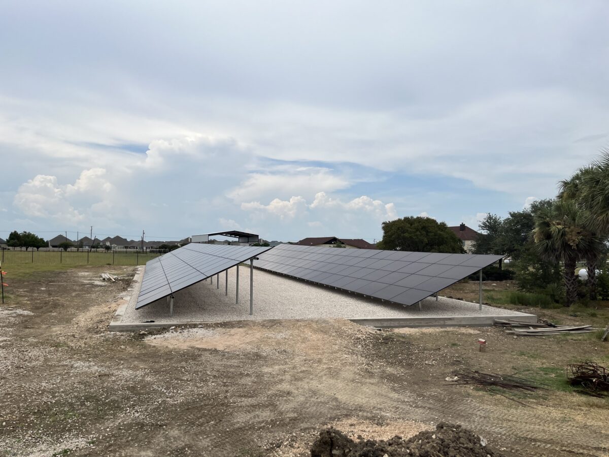 Ground-mount solar array feeding a Powerwall 3 system, Pflugerville, Texas