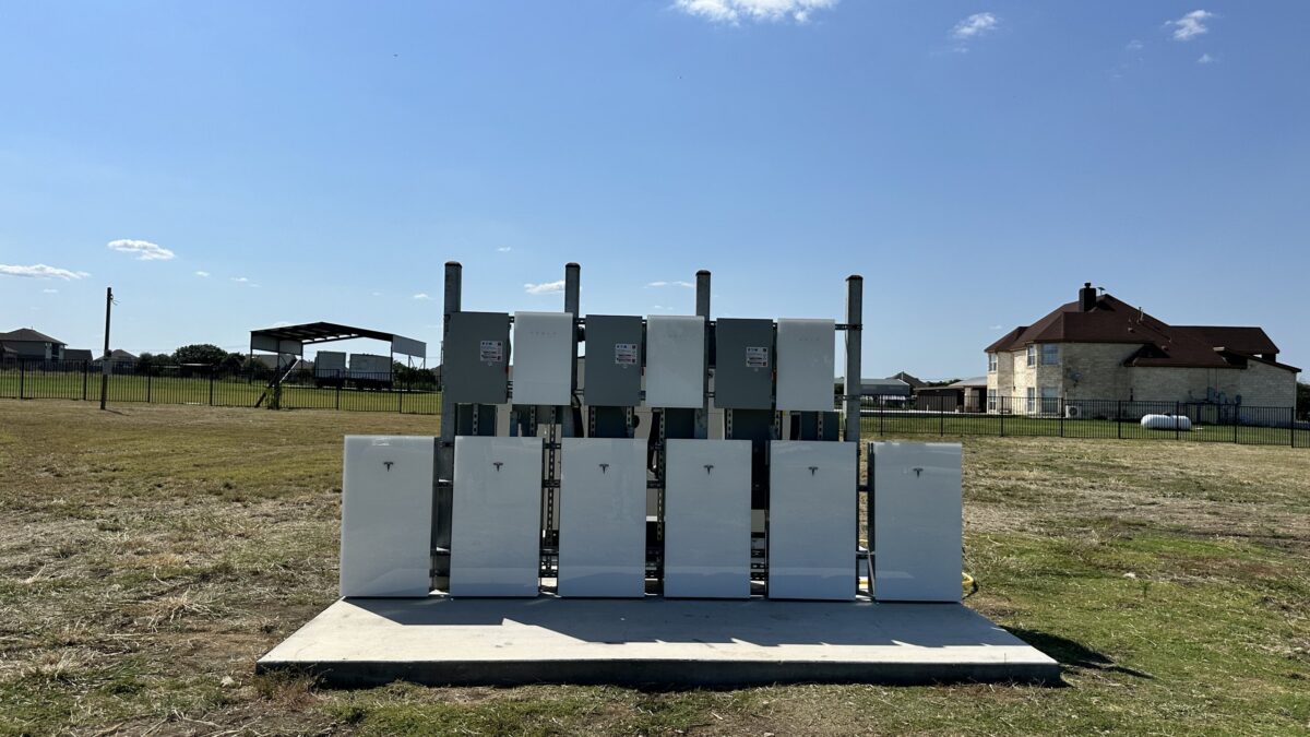 Six Tesla Powerwall 3 batteries installed on a concrete pad, Pflugerville, Texas